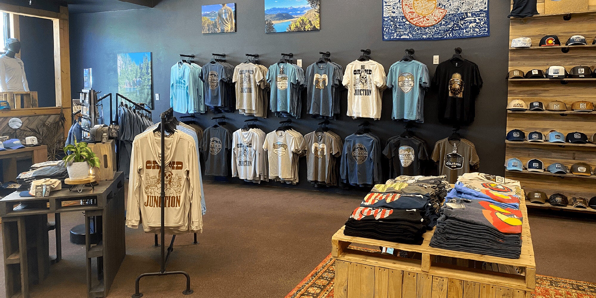 Image of the inside of the ColoradoCool Apparel retail shop in downtown Grand Junction displaying t-shirts and hats