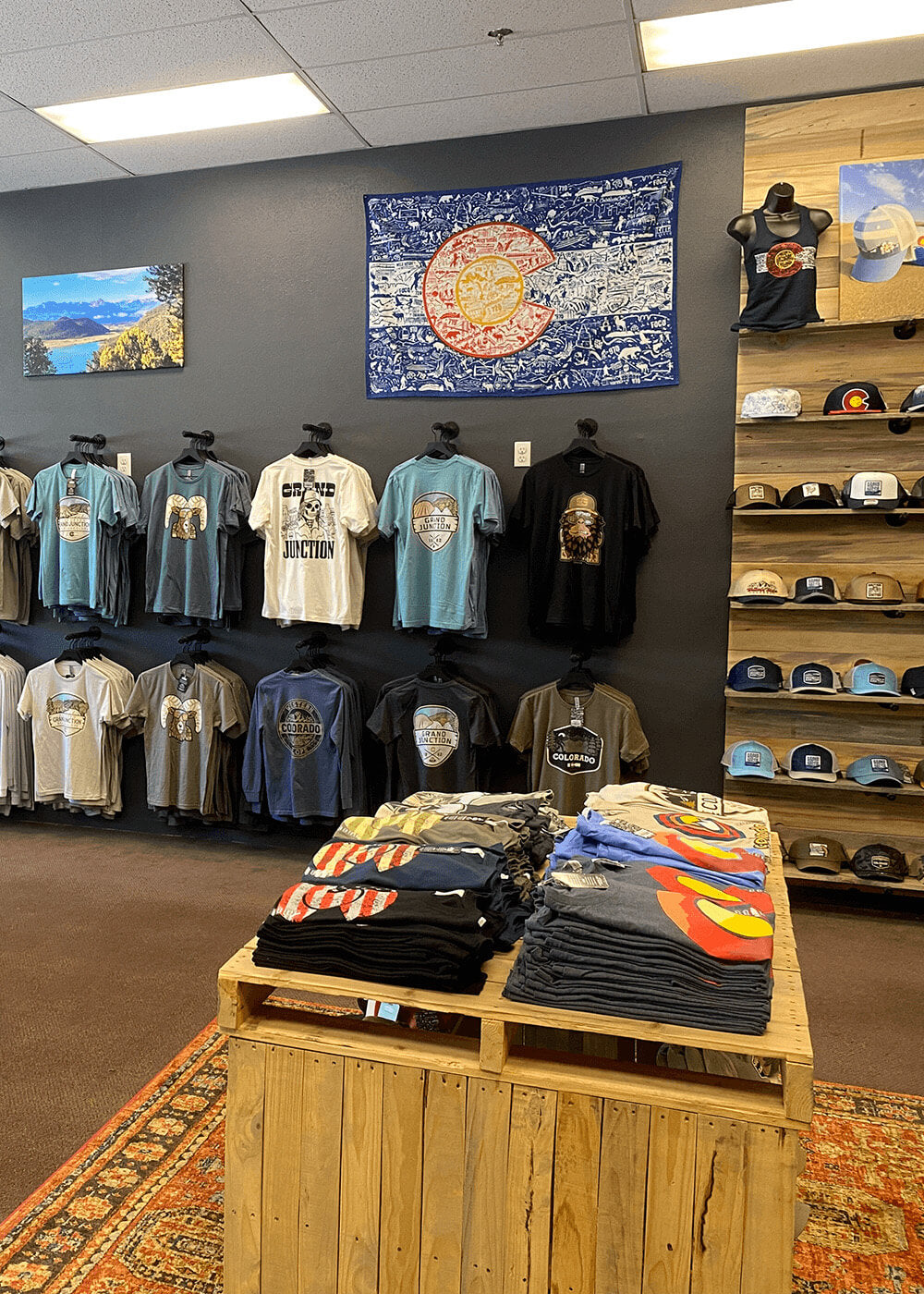 Image of the inside of the ColoradoCool Apparel retail shop in downtown Grand Junction displaying t-shirts and hats