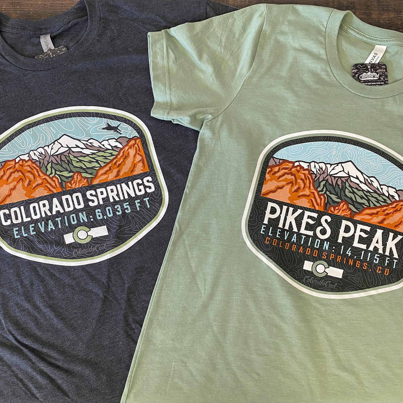 Two Colorado Springs graphic t-shirts depicting Pikes Peak with Garden of the Gods in front